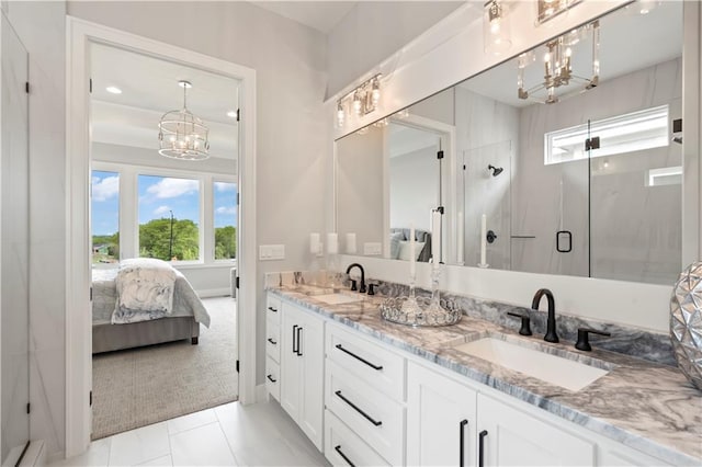 bathroom featuring vanity, tile patterned flooring, a chandelier, and walk in shower