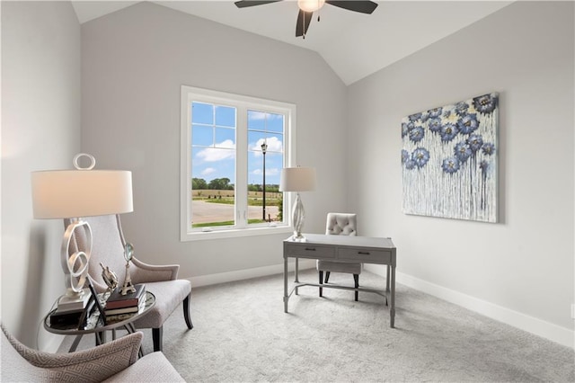 carpeted home office with ceiling fan and vaulted ceiling