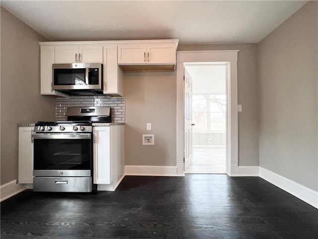 kitchen featuring white cabinetry, decorative backsplash, dark wood-type flooring, and stainless steel appliances