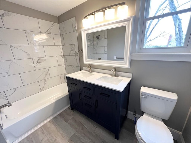 full bathroom with vanity, toilet, and tiled shower / bath combo