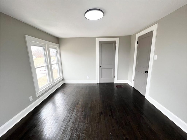 empty room featuring dark wood-type flooring