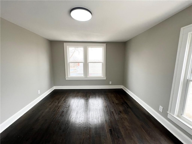 spare room featuring dark wood-type flooring