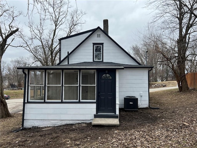 view of front of home featuring central AC and a sunroom