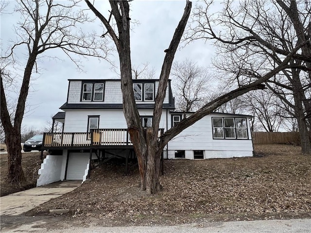 view of front of home featuring a wooden deck and a garage