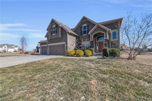 view of front of house featuring a garage, driveway, a front lawn, and stucco siding