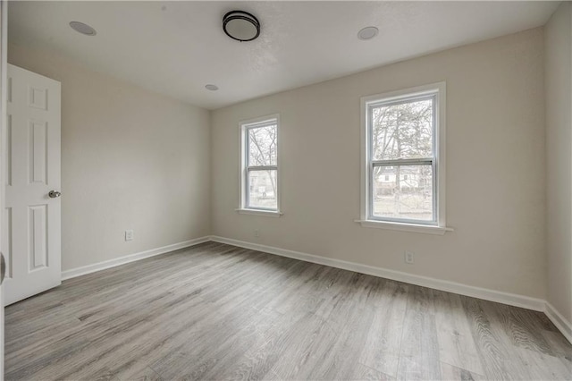 unfurnished room with light wood-type flooring