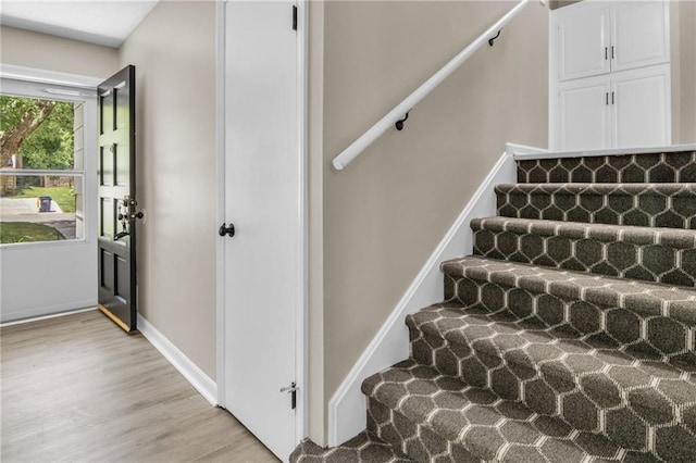 stairway with hardwood / wood-style floors