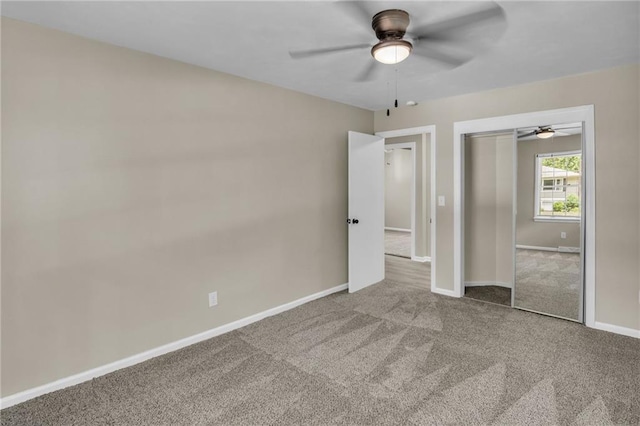 unfurnished bedroom with carpet, ceiling fan, and a closet