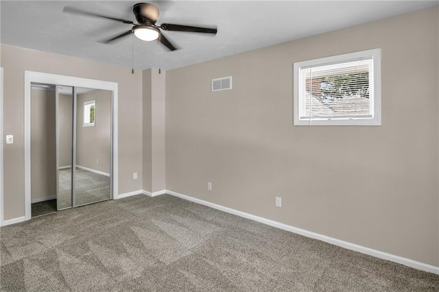 unfurnished bedroom featuring ceiling fan, a closet, and carpet