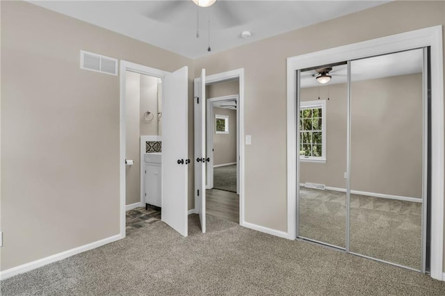 unfurnished bedroom featuring carpet floors, ceiling fan, and a closet