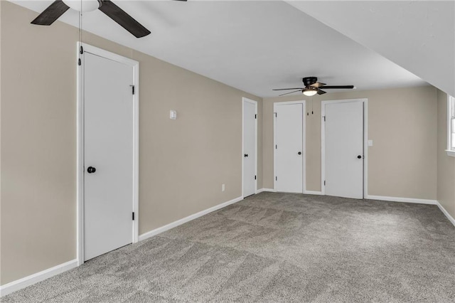 interior space with multiple closets, ceiling fan, and light carpet