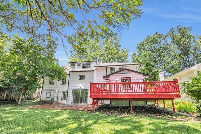 rear view of property featuring a wooden deck, a yard, and cooling unit