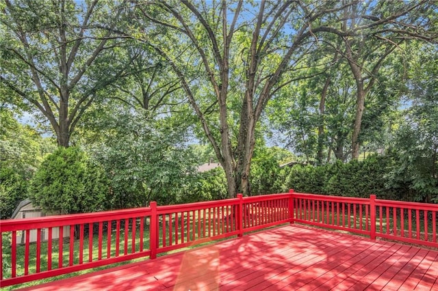 wooden deck featuring a storage shed