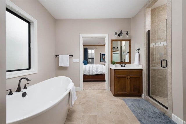 bathroom featuring vanity and independent shower and bath