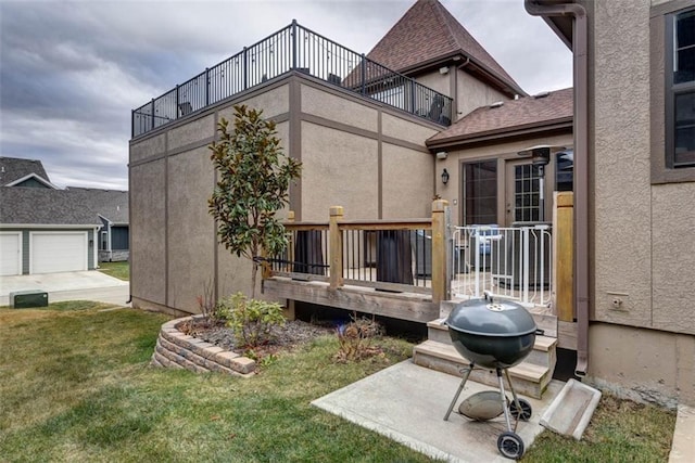 exterior space featuring a garage, a yard, and a balcony