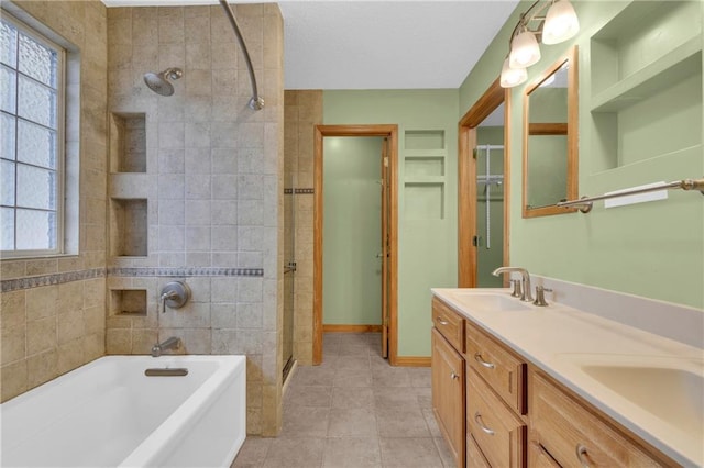 bathroom with vanity, tile patterned flooring, and tiled shower / bath combo