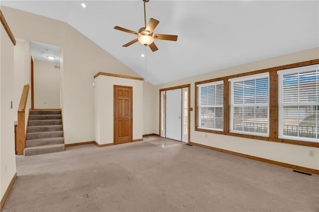 unfurnished living room featuring ceiling fan, vaulted ceiling, and light carpet