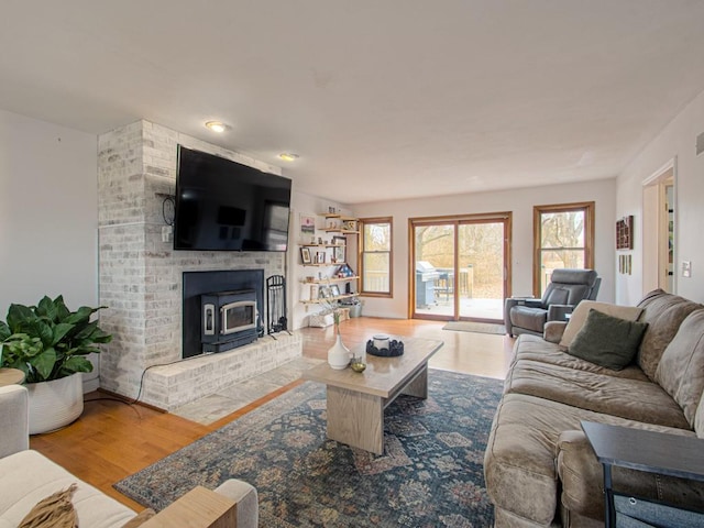 living room with hardwood / wood-style floors and a wood stove