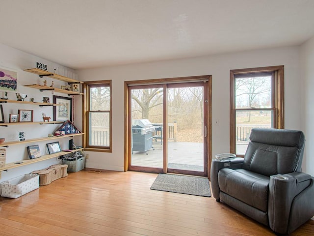 sitting room with a wealth of natural light and light wood-type flooring