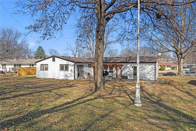 view of front of home with a front lawn, fence, and a pergola