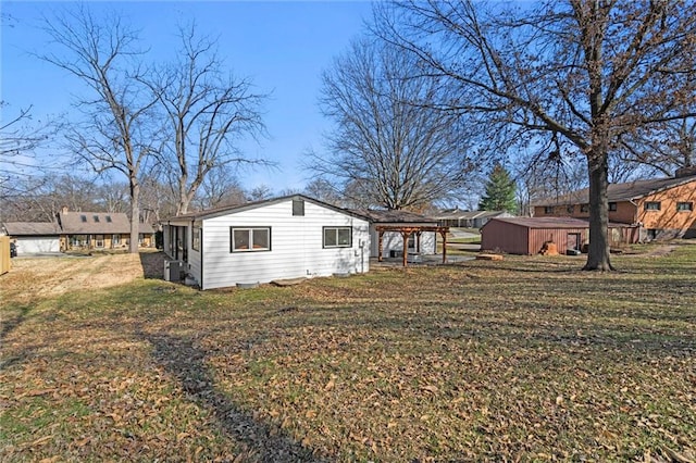 exterior space featuring central air condition unit and a lawn