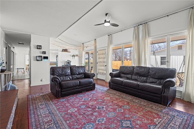 living room with a wealth of natural light, wood finished floors, and ceiling fan