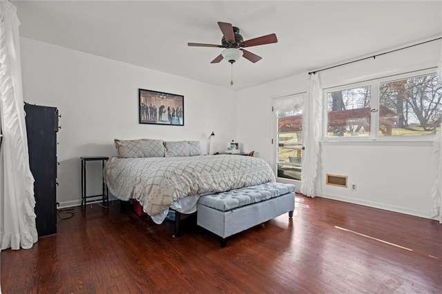 bedroom featuring visible vents, access to exterior, wood finished floors, baseboards, and ceiling fan