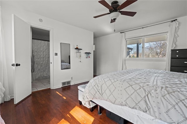 bedroom featuring visible vents, baseboards, wood finished floors, and a ceiling fan