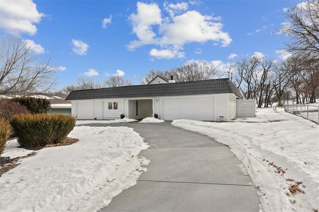 ranch-style house featuring a tile roof, fence, and an attached garage