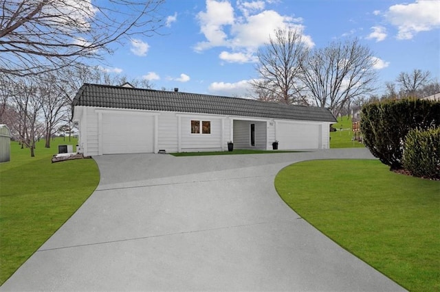 ranch-style house featuring a front yard, concrete driveway, and a tiled roof