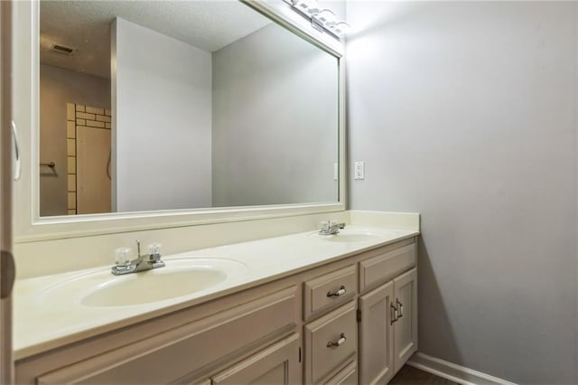 bathroom featuring vanity and a textured ceiling