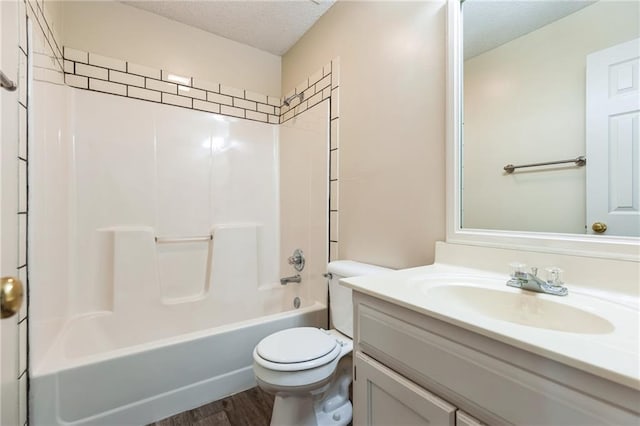 full bathroom with hardwood / wood-style flooring, shower / bath combination, vanity, a textured ceiling, and toilet