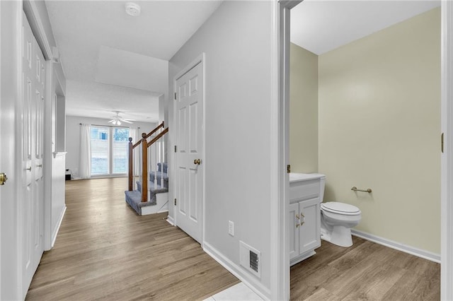 hallway with light hardwood / wood-style floors