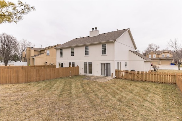 back of property with a yard and a patio