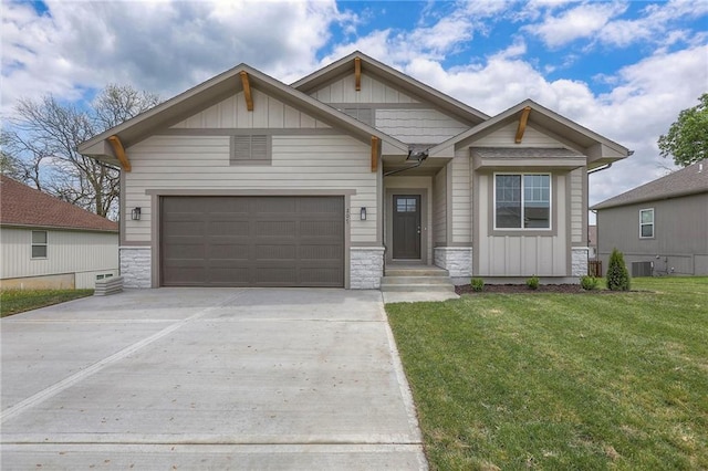 view of front facade featuring board and batten siding, central AC unit, concrete driveway, and stone siding