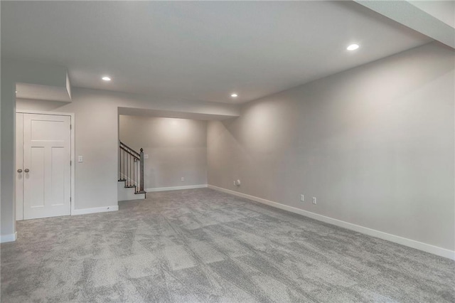 basement with stairway, recessed lighting, baseboards, and carpet floors