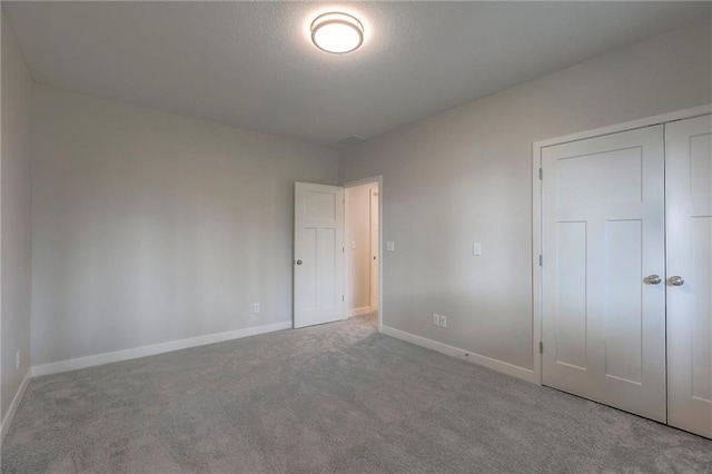 unfurnished bedroom featuring baseboards and carpet floors