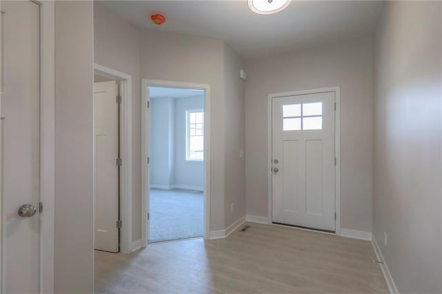 entrance foyer with baseboards and light wood-type flooring