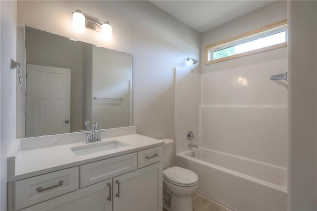 bathroom with toilet, shower / tub combination, and vanity
