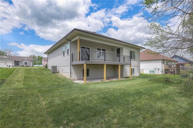 back of property featuring a lawn and central air condition unit