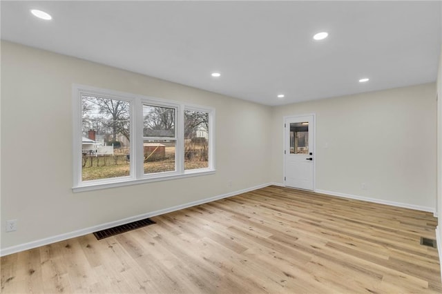 empty room with light hardwood / wood-style floors