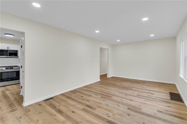 spare room with light hardwood / wood-style floors