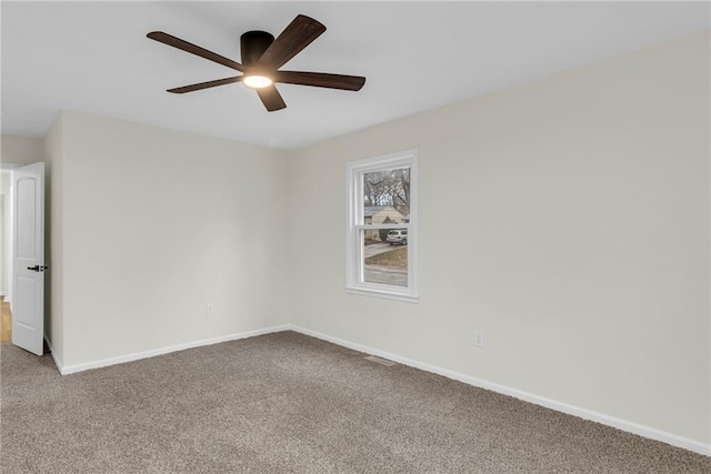 empty room with ceiling fan and carpet floors