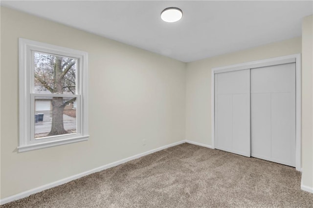 unfurnished bedroom featuring a closet and light carpet