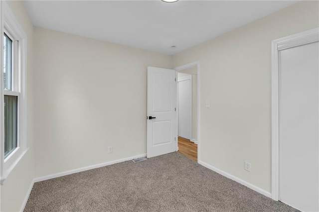 unfurnished bedroom with carpet floors