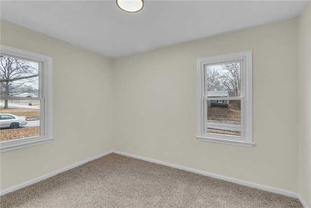 empty room with plenty of natural light and carpet