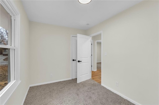 unfurnished bedroom featuring light colored carpet