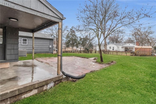 view of yard featuring central AC and a patio