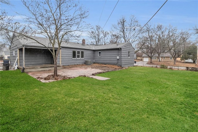 rear view of property featuring a yard, central AC, and a patio