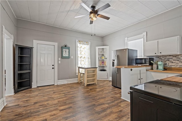 kitchen with white cabinets, ceiling fan, dark wood finished floors, and backsplash